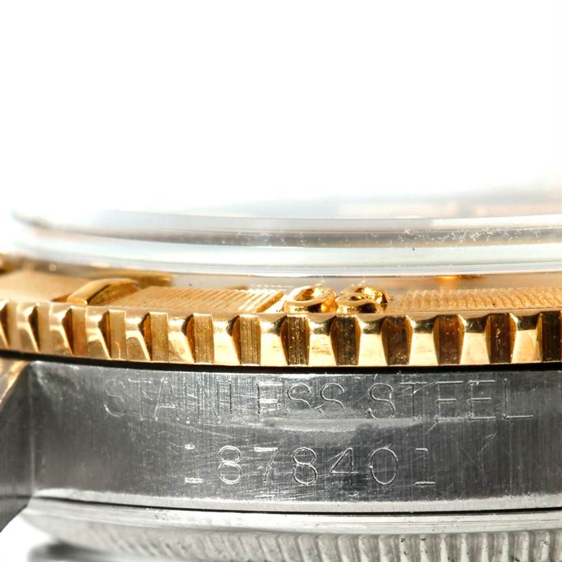 Close-up of the bezel, crystal, and side engraving of a Rolex Vintage Collection 1625 Men's Steel and Gold (two tone) Silver Dial 1625 Men's Steel and Gold (two tone) Silver Dial watch showing its stainless steel material and serial number.