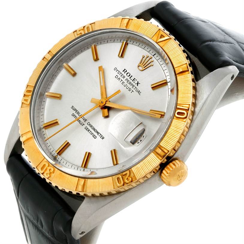 The Vintage Collection Rolex watch is shown at a tilted angle, highlighting its dial, bezel, and crown.