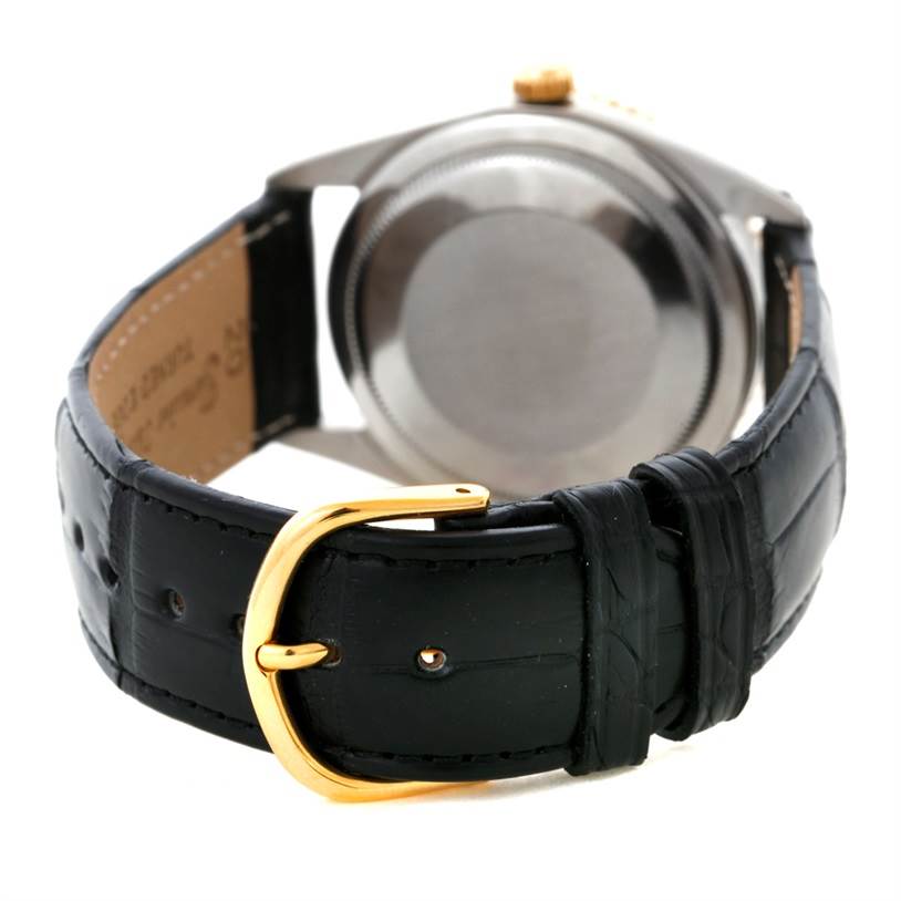 The image shows the back view of a Vintage Collection model Rolex watch with a black leather strap and gold buckle.