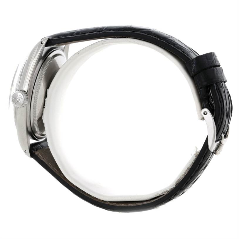 The image shows the side view of a Rolex Vintage Collection 1603 Men's Stainless Steel Silver Dial 1603 Men's Stainless Steel Silver Dial watch, highlighting the case, crown, and leather strap.