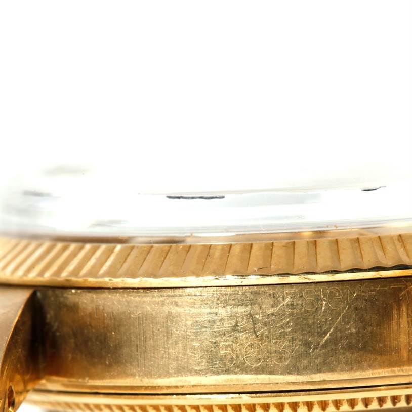 The image shows a close-up side view of the Vintage Collection model by Rolex, focusing on the gold bezel and edge of the crystal.