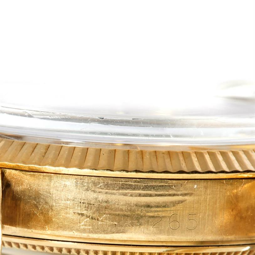 This image shows a close-up of the side of a Rolex Vintage Collection 1503 Men's Yellow Gold Silver Dial 1503 Men's Yellow Gold Silver Dial watch, focusing on the bezel and part of the case.