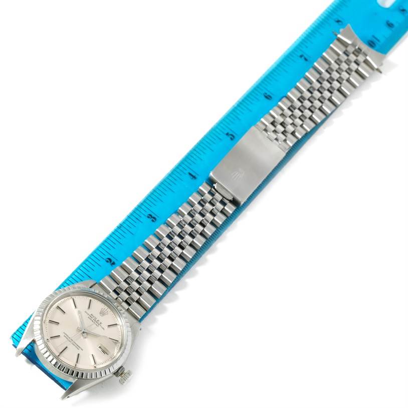 The image shows a Rolex Vintage Collection 1603 Men's Stainless Steel Silver Dial 1603 Men's Stainless Steel Silver Dial watch laid flat, with the dial, bracelet, and clasp visible, alongside a blue ruler for scale.