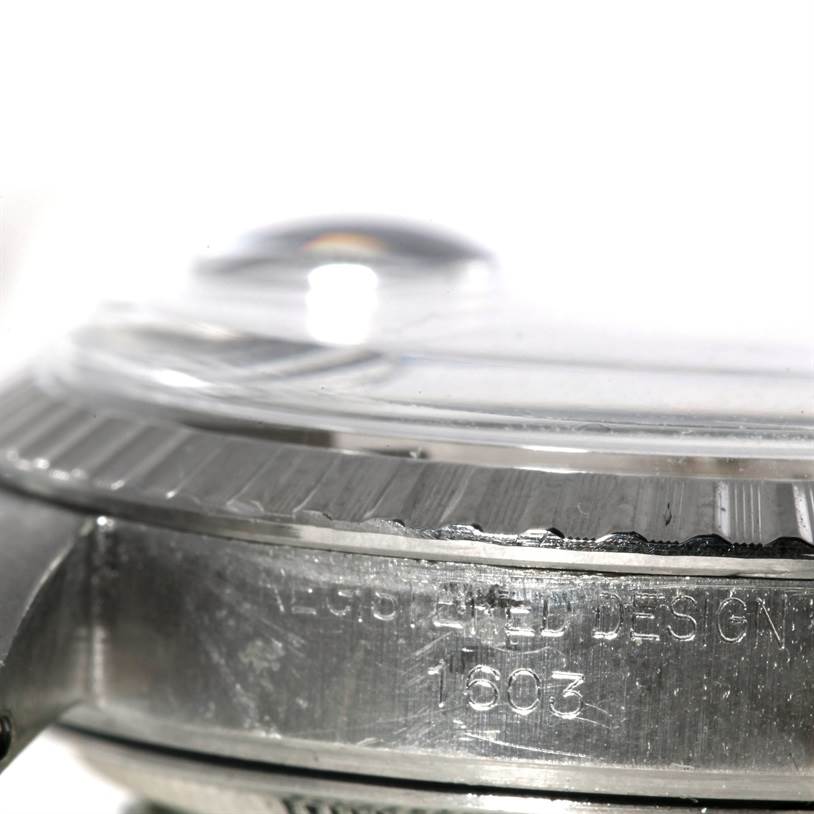 The image shows a side-angle close-up of a Rolex Vintage Collection 1603 Men's Stainless Steel Silver Dial 1603 Men's Stainless Steel Silver Dial model watch with focus on the bezel and engraved case.