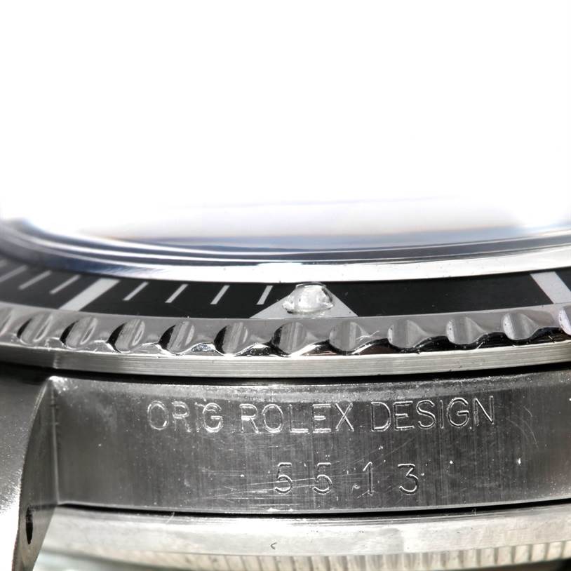 This close-up image of the Rolex Vintage Collection 5513 Men's Stainless Steel Black Dial 5513 Men's Stainless Steel Black Dial watch shows the bezel and engraved case side.