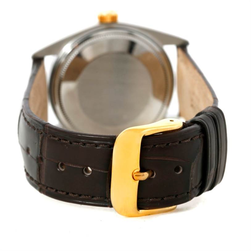 This image shows the Rolex Vintage Collection 1601 Men's Stainless Steel Silver Dial 1601 Men's Stainless Steel Silver Dial watch's back case and leather strap with a gold buckle, viewed from the rear angle.