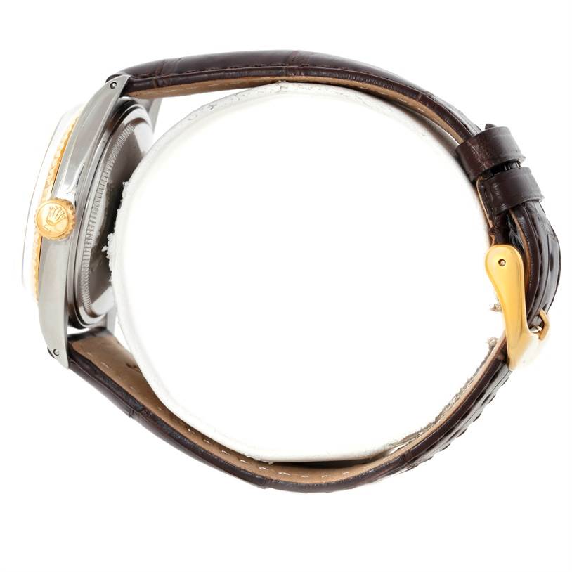 The image shows a side view of a Rolex Vintage Collection 1601 Men's Stainless Steel Silver Dial 1601 Men's Stainless Steel Silver Dial watch, highlighting the crown, case, and brown leather strap with a gold buckle.