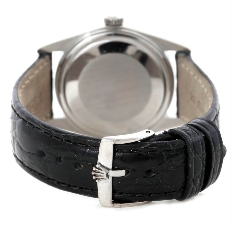 The image shows the back case and clasp of a Rolex Vintage Collection 16030 Men's Stainless Steel White Dial 16030 Men's Stainless Steel White Dial model watch, highlighting the black leather strap and metal buckle.