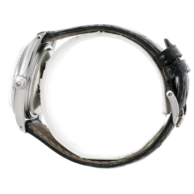 The watch is a Vintage Collection model by Rolex, shown from a side view displaying the crown, case, and leather strap with buckle.