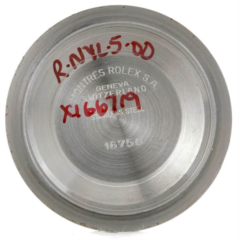 This image shows the inside case back of a Vintage Collection Rolex watch, with engraving and some markings.