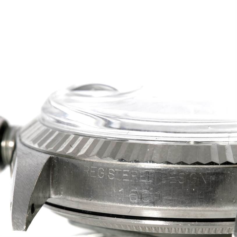 This image shows a close-up side angle of the case and bezel of the Rolex Vintage Collection 1601 Men's Stainless Steel Silver Dial 1601 Men's Stainless Steel Silver Dial model watch.