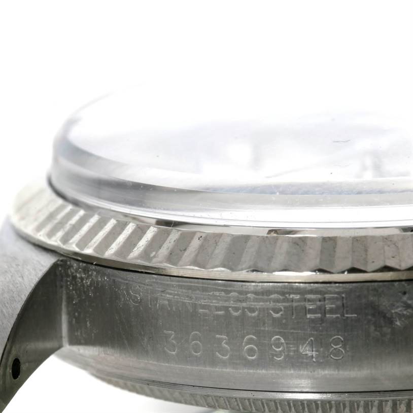 The image shows a close-up of the side and bezel of a Rolex Vintage Collection 1601 Men's Stainless Steel Silver Dial 1601 Men's Stainless Steel Silver Dial watch, including the case edge and serial number.
