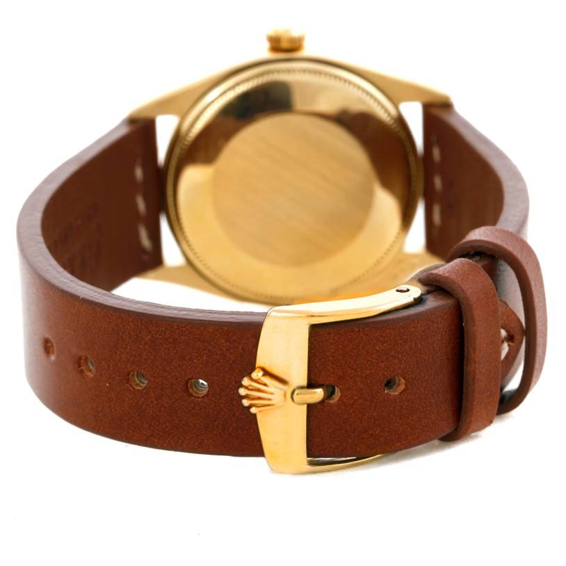 The image shows the back case and leather strap with buckle details of a Vintage Collection model watch by Rolex.