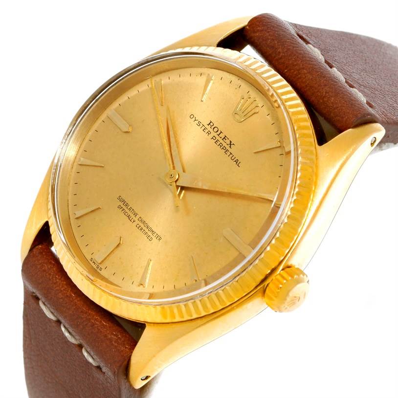 This image shows the face, bezel, crown, and part of the strap of a Vintage Collection model by Rolex.