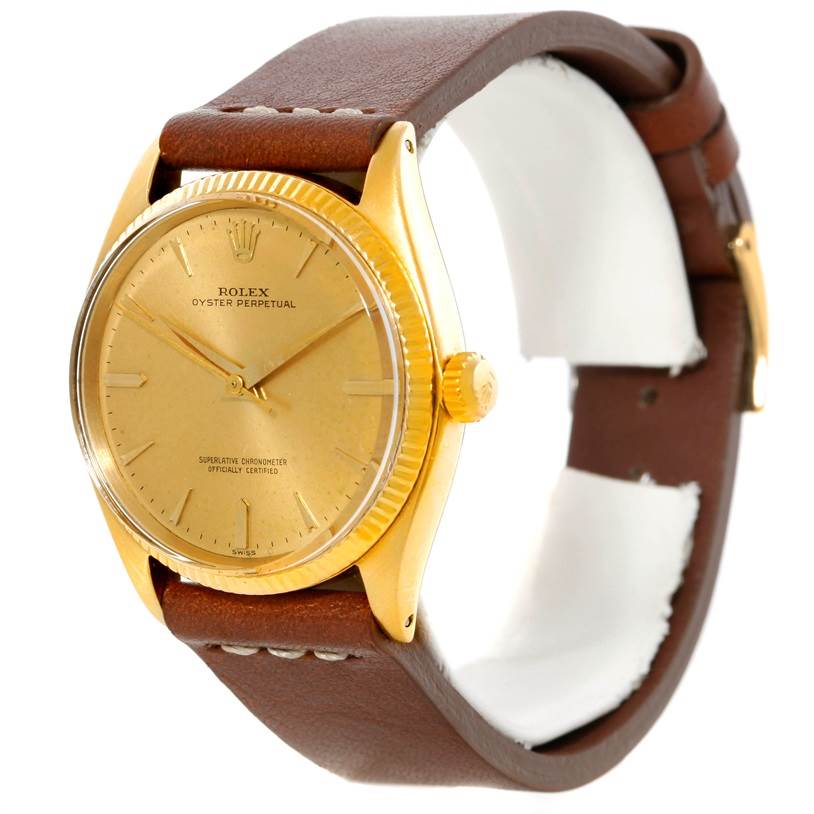 The image shows a Rolex Vintage Collection 1005 Men's Yellow Gold Champagne Dial 1005 Men's Yellow Gold Champagne Dial watch from an angled side view, displaying its face, bezel, and leather strap.