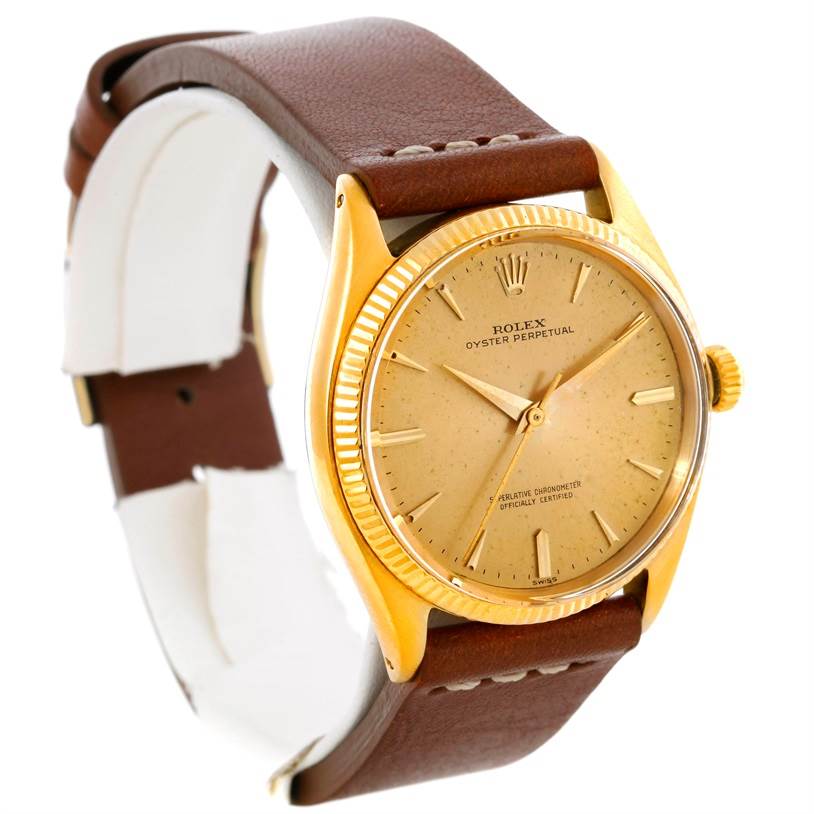 The Vintage Collection Rolex watch is shown from a three-quarter angle, detailing the dial, bezel, and brown leather strap.
