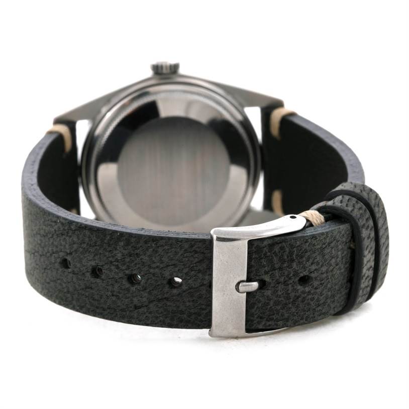 The image shows the back case and black leather strap of a Vintage Collection model by Rolex at a rear angle.