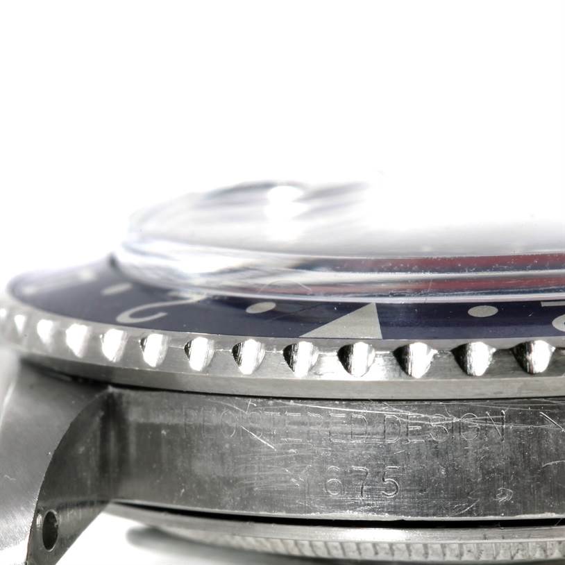 The image shows a side view of the bezel, crystal, and part of the case of a Rolex Vintage Collection 1675 Men's Stainless Steel Black Dial 1675 Men's Stainless Steel Black Dial watch.