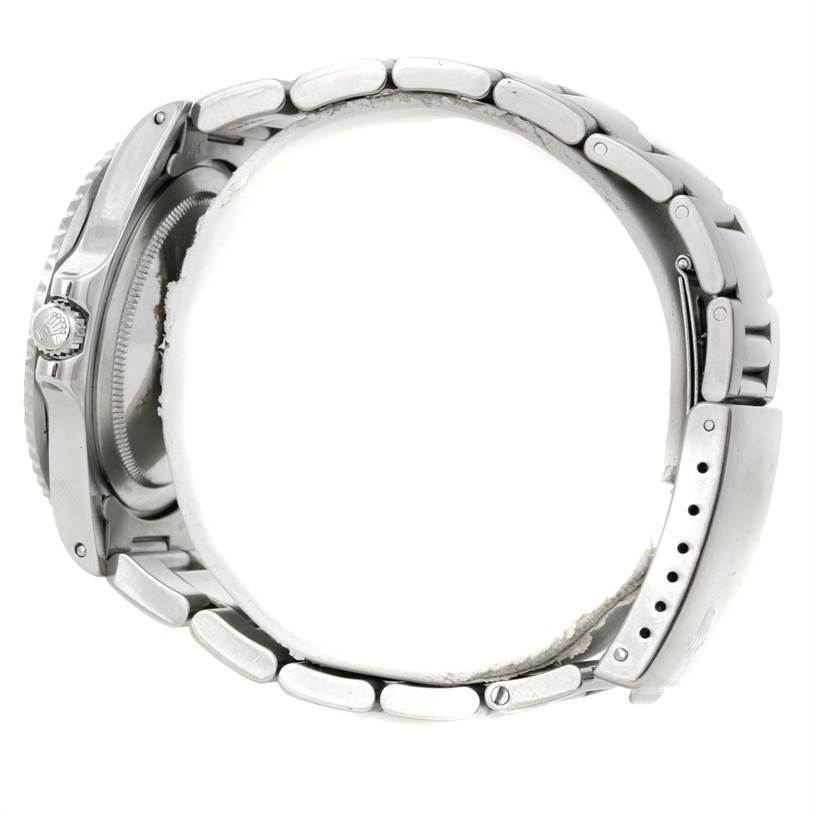 The image shows a side view of the Rolex Vintage Collection 1675 Men's Stainless Steel Black Dial 1675 Men's Stainless Steel Black Dial watch, highlighting the metal bracelet, case, and crown.