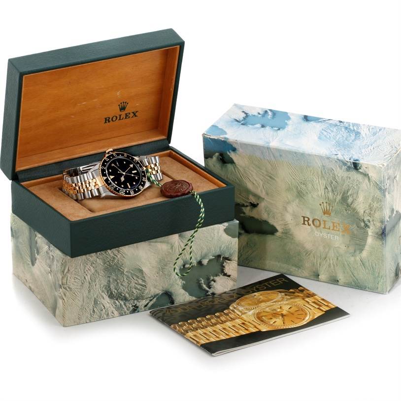 The image showcases a Rolex Vintage Collection 16753 Men's Stainless Steel Black Dial 16753 Men's Stainless Steel Black Dial watch in an open box with a certificate, outer box, and booklet.