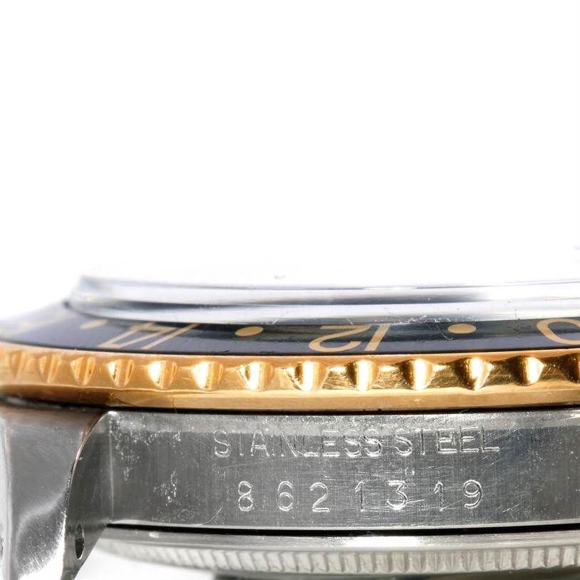 This image shows a close-up side view of the bezel and part of the case of a Rolex Vintage Collection 16753 Men's Stainless Steel Black Dial 16753 Men's Stainless Steel Black Dial watch, revealing its stainless steel material and serial number.