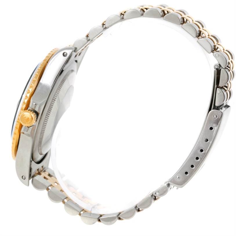 The Vintage Collection Rolex watch is shown from a side angle, displaying its two-tone case, crown, and metal bracelet.