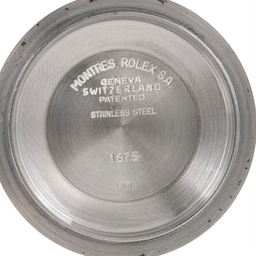 The image shows the inner case back of a Rolex Vintage Collection 1675 Men's Stainless Steel Black Dial 1675 Men's Stainless Steel Black Dial watch, which is made of stainless steel.