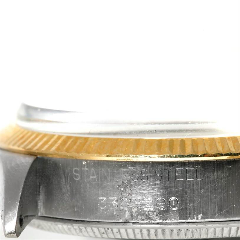 The image shows a close-up of the side of a Rolex Vintage Collection 5501 Men's Steel and Gold (two tone) Silver Dial 5501 Men's Steel and Gold (two tone) Silver Dial watch, highlighting the stainless steel case and the fluted bezel.