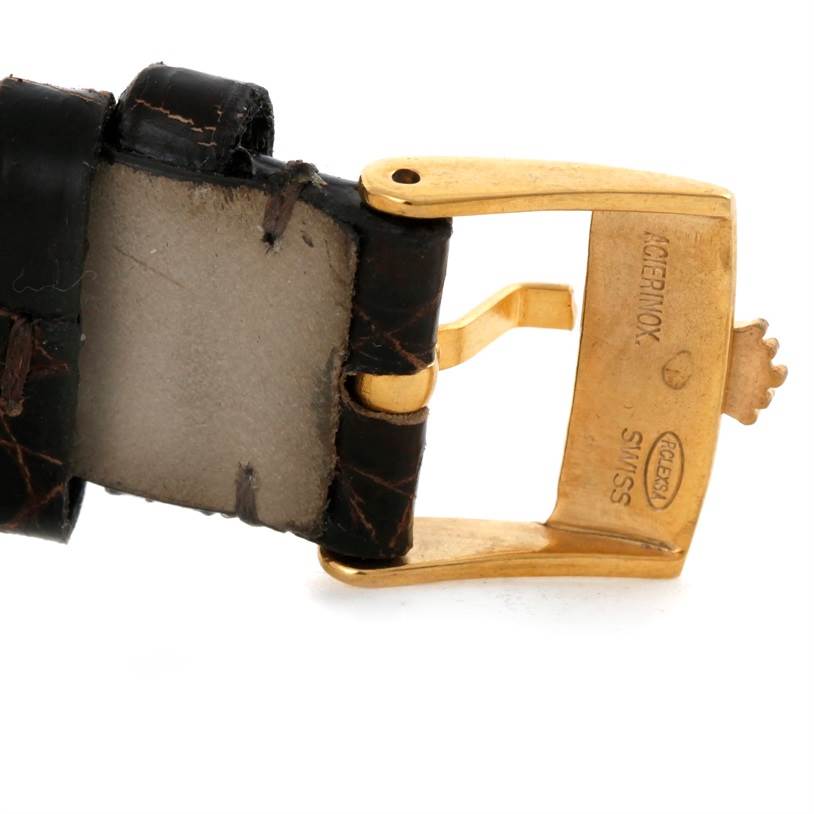 The image shows a close-up of a gold buckle and leather strap from a Vintage Collection watch by Rolex.