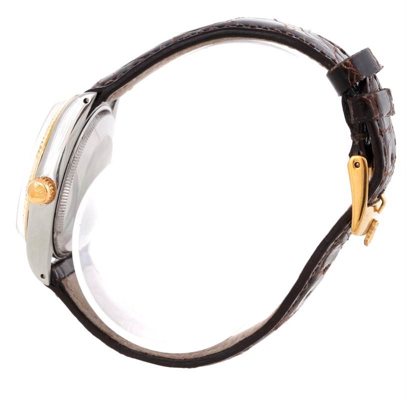 The image shows a side view of a Rolex Vintage Collection 5501 Men's Steel and Gold (two tone) Silver Dial 5501 Men's Steel and Gold (two tone) Silver Dial model watch featuring its crown, case, and leather strap.