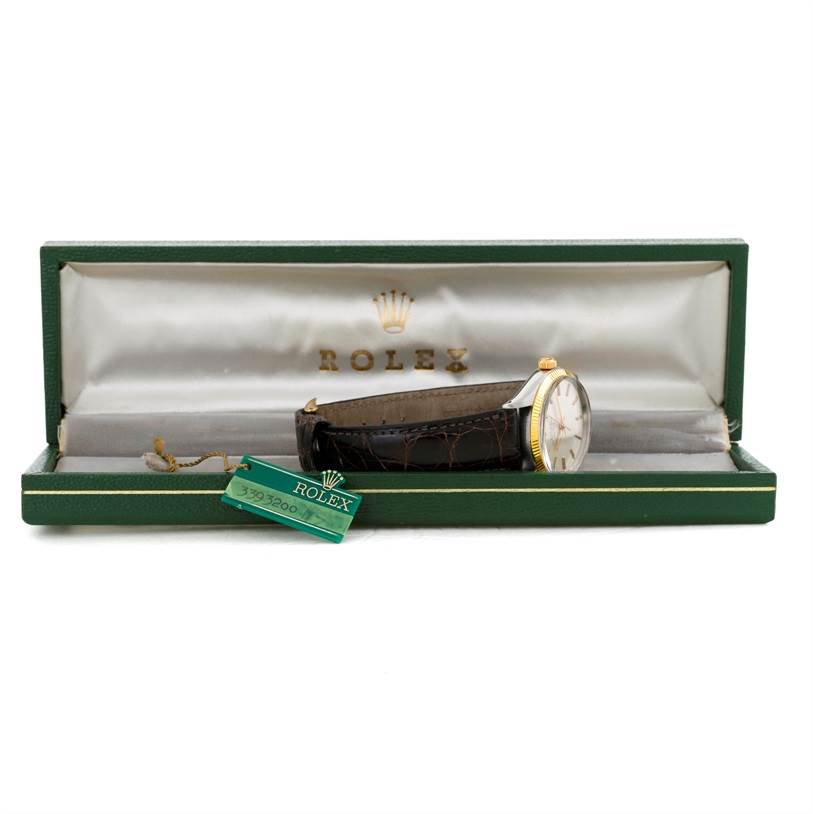 The Vintage Collection Rolex watch is shown from a side angle in its green box, highlighting the strap, dial, and price tag.