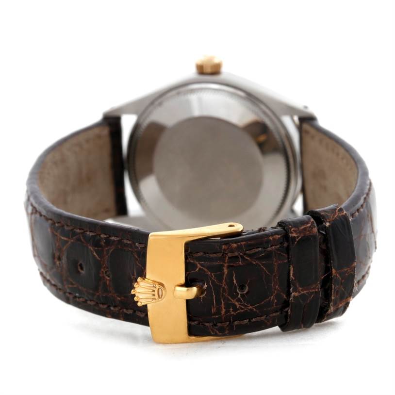 The Rolex Vintage Collection 5501 Men's Steel and Gold (two tone) Silver Dial 5501 Men's Steel and Gold (two tone) Silver Dial watch is shown from the back, highlighting the clasp, leather strap, and case back.