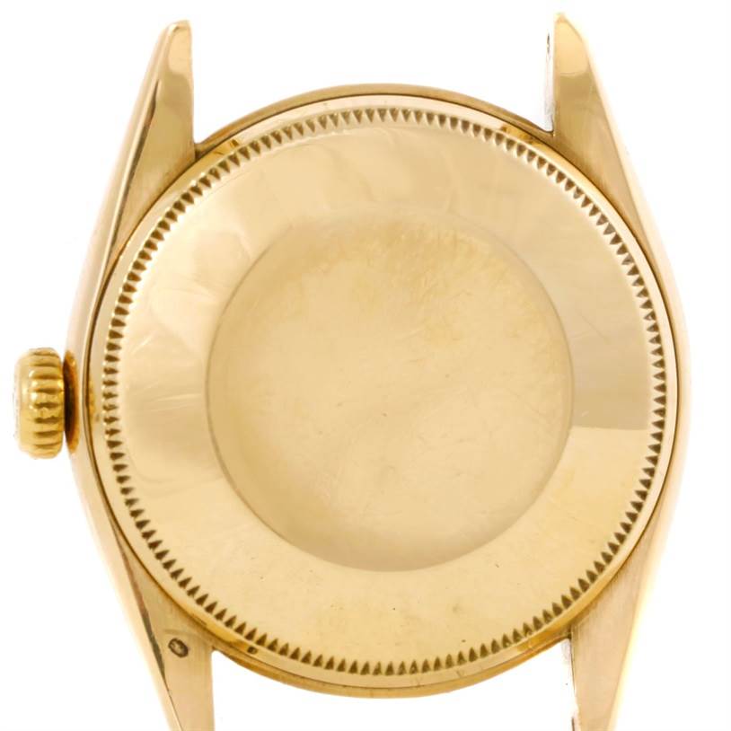 The image shows the back case, crown, and lugs of a Vintage Collection Rolex watch, viewed from the rear.