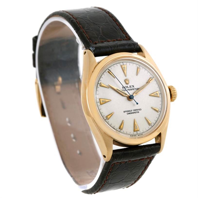 The image shows a side angle of the Rolex Vintage Collection 6084 Men's Yellow Gold Silver Dial 6084 Men's Yellow Gold Silver Dial watch, highlighting its gold case and black leather strap.