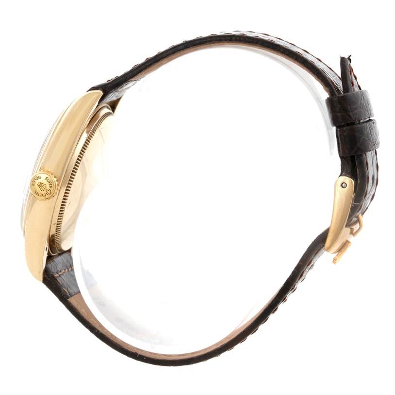 The image shows a side view of the Rolex Vintage Collection 6084 Men's Yellow Gold Silver Dial 6084 Men's Yellow Gold Silver Dial watch, highlighting the gold case and leather strap.