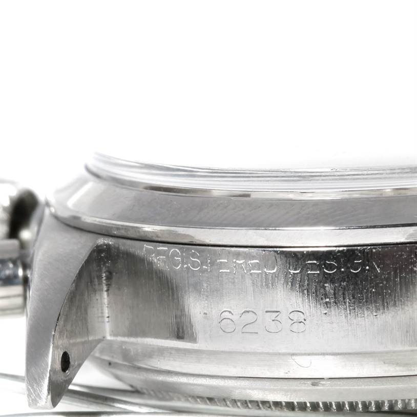 The image shows a close-up side profile of a Rolex Vintage Collection 6238 Men's Stainless Steel Silver Dial 6238 Men's Stainless Steel Silver Dial model watch, focusing on the engraved case and lugs.