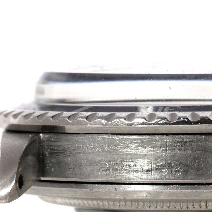 This image shows a close-up, side-angle view of the case and bezel with serial number section of the Rolex Vintage Collection 1680 Men's Stainless Steel Black Dial 1680 Men's Stainless Steel Black Dial model.