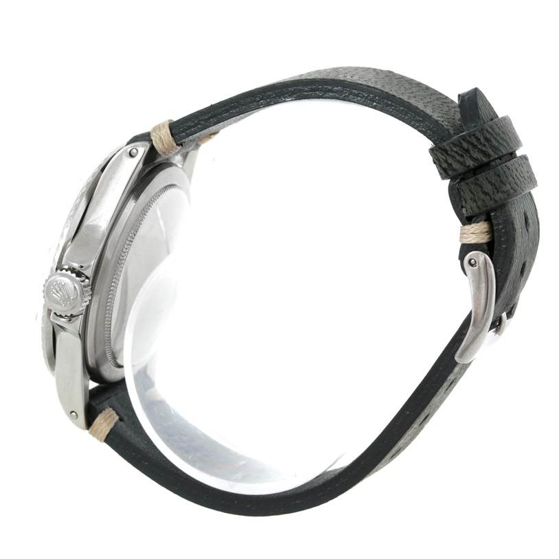 The image shows the side profile of a Rolex Vintage Collection 1680 Men's Stainless Steel Black Dial 1680 Men's Stainless Steel Black Dial watch, highlighting the crown, case, and leather strap with buckle.