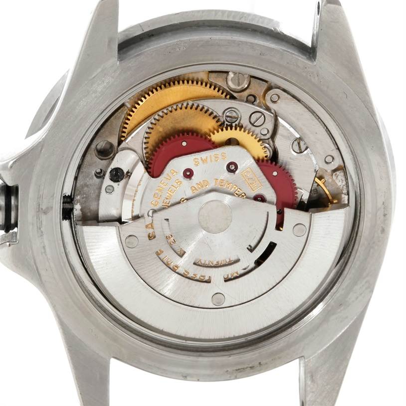 This image shows the internal mechanism of a Rolex Vintage Collection 1680 Men's Stainless Steel Black Dial 1680 Men's Stainless Steel Black Dial watch from a rear angle, revealing gears and rotor.