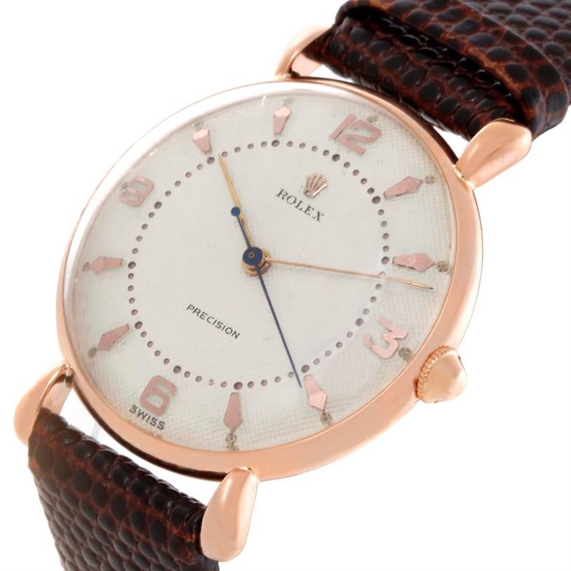 The Rolex Vintage Collection Men's Rose Gold White Dial Men's Rose Gold White Dial watch is shown from a front angle, displaying its dial, rose gold case, and brown leather strap.