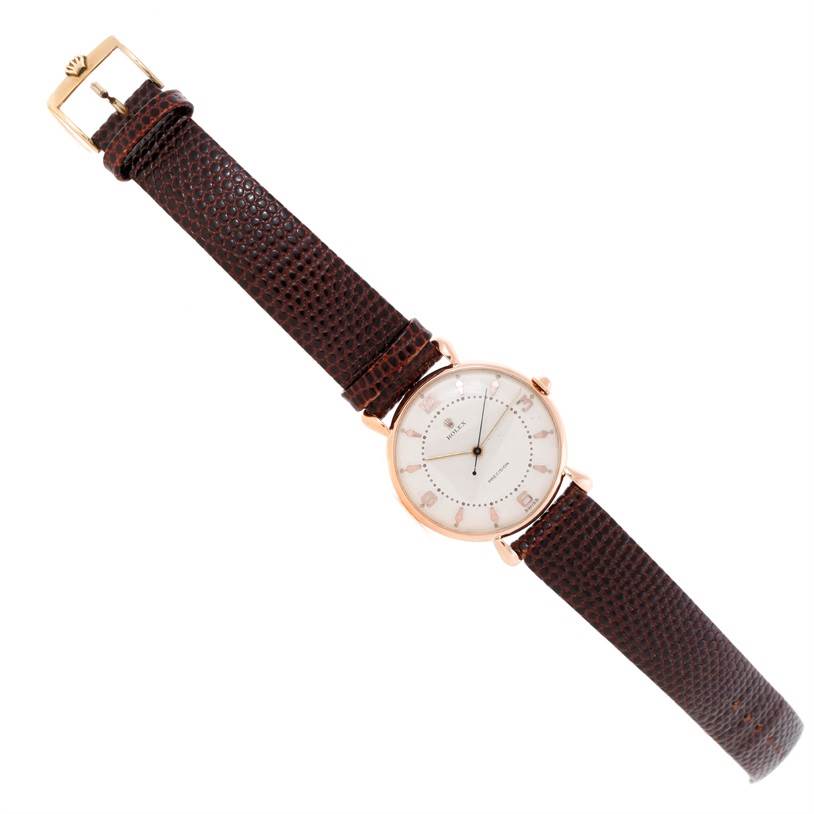 The Rolex Vintage Collection Men's Rose Gold White Dial Men's Rose Gold White Dial model is shown from an overhead angle, displaying the full dial and leather strap.