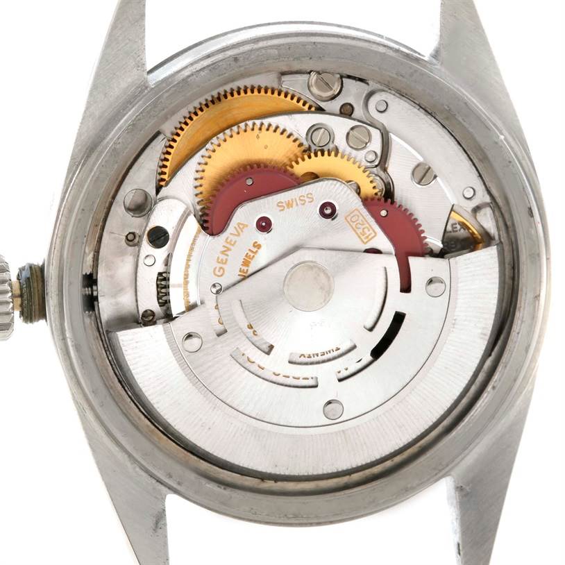 The image shows the internal mechanism of a Rolex Vintage Collection 1601 Stainless Steel Silver Dial 1601 Stainless Steel Silver Dial model, including gears, rotors, and the winding crown.