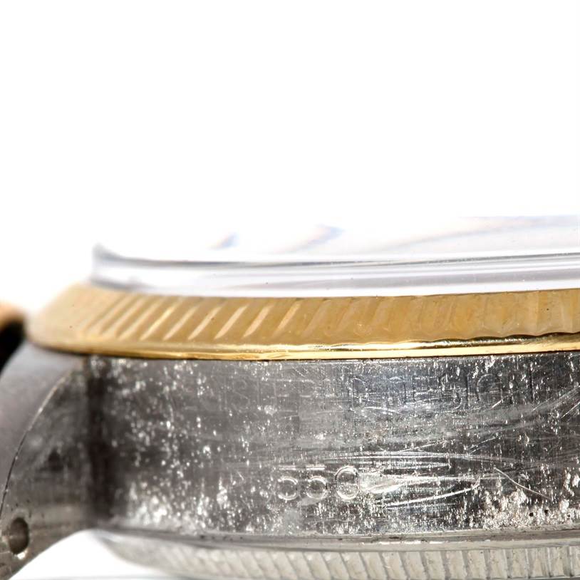 The image shows a close-up side angle of the Rolex Vintage Collection 5501 Men's Steel and Gold (two tone) Silver Dial 5501 Men's Steel and Gold (two tone) Silver Dial watch, highlighting the bezel and part of the watch case.