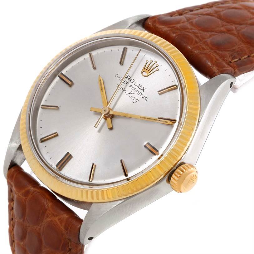 The image shows a close-up angle of a Rolex Vintage Collection 5501 Men's Steel and Gold (two tone) Silver Dial 5501 Men's Steel and Gold (two tone) Silver Dial watch, highlighting the dial, crown, bezel, and part of the brown leather strap.