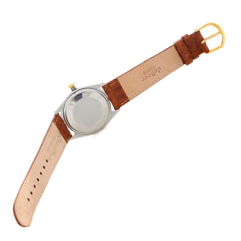 The Rolex Vintage Collection 5501 Men's Steel and Gold (two tone) Silver Dial 5501 Men's Steel and Gold (two tone) Silver Dial watch is shown from the back, highlighting the leather strap and the watch case back.