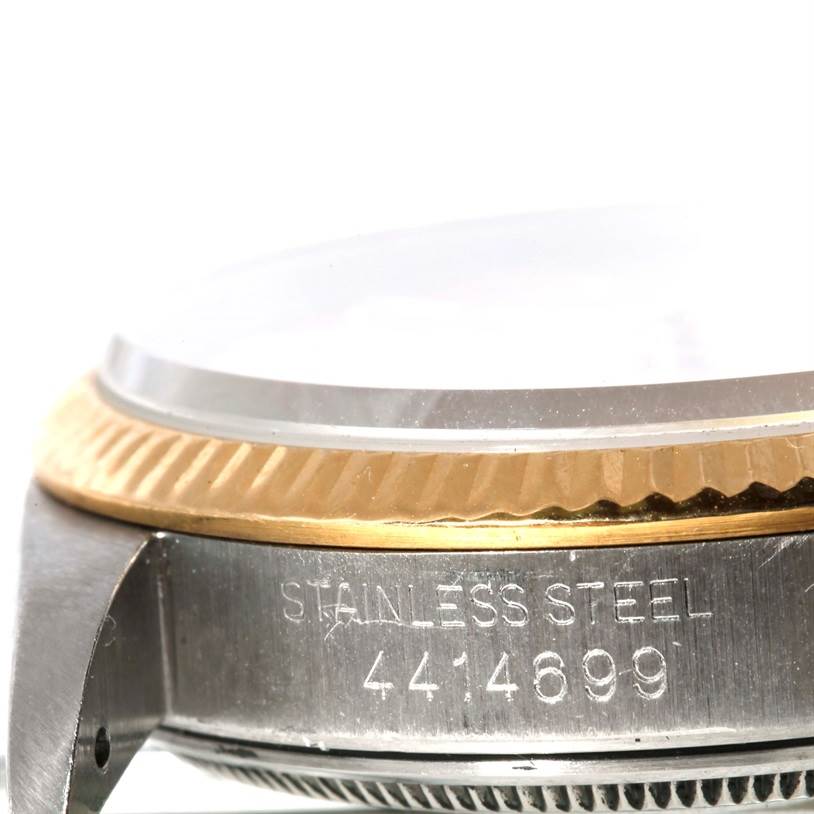 This image shows the side view of a Vintage Collection Rolex watch, focusing on the stainless steel case and engraved serial number.