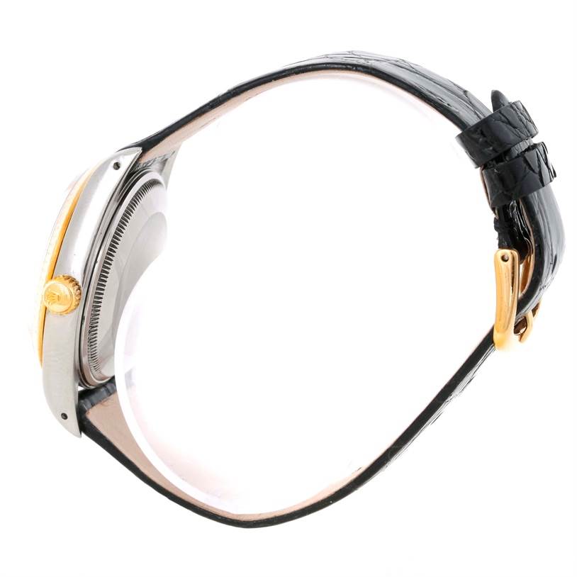 Side view of the Rolex Vintage Collection 14203 Men's Steel and Gold (two tone) Champagne Dial 14203 Men's Steel and Gold (two tone) Champagne Dial watch, showing its crown, case, and leather strap with a buckle.