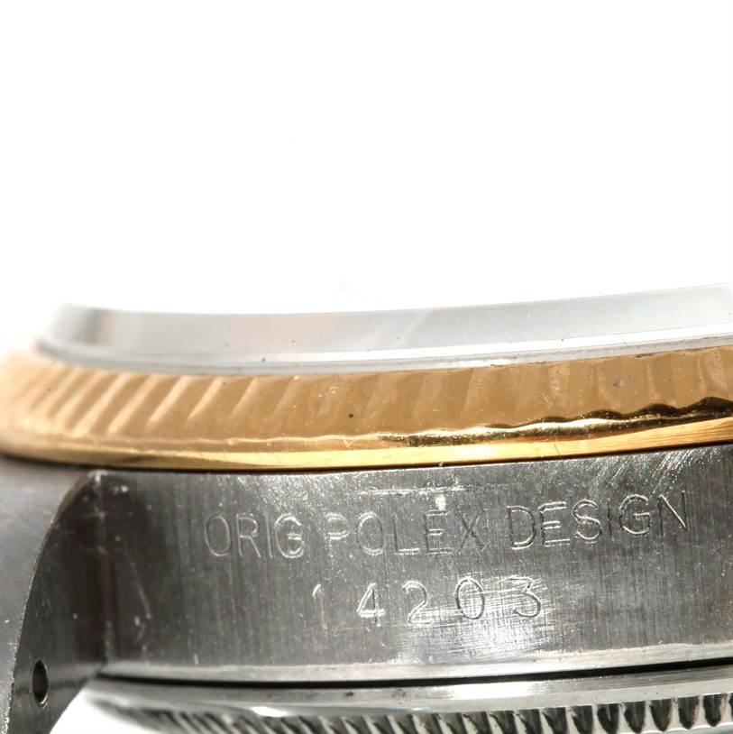 This image shows a close-up of the side of the watch case and bezel of a Rolex Vintage Collection 14203 Men's Steel and Gold (two tone) Champagne Dial 14203 Men's Steel and Gold (two tone) Champagne Dial model, featuring engraved text and detailing.