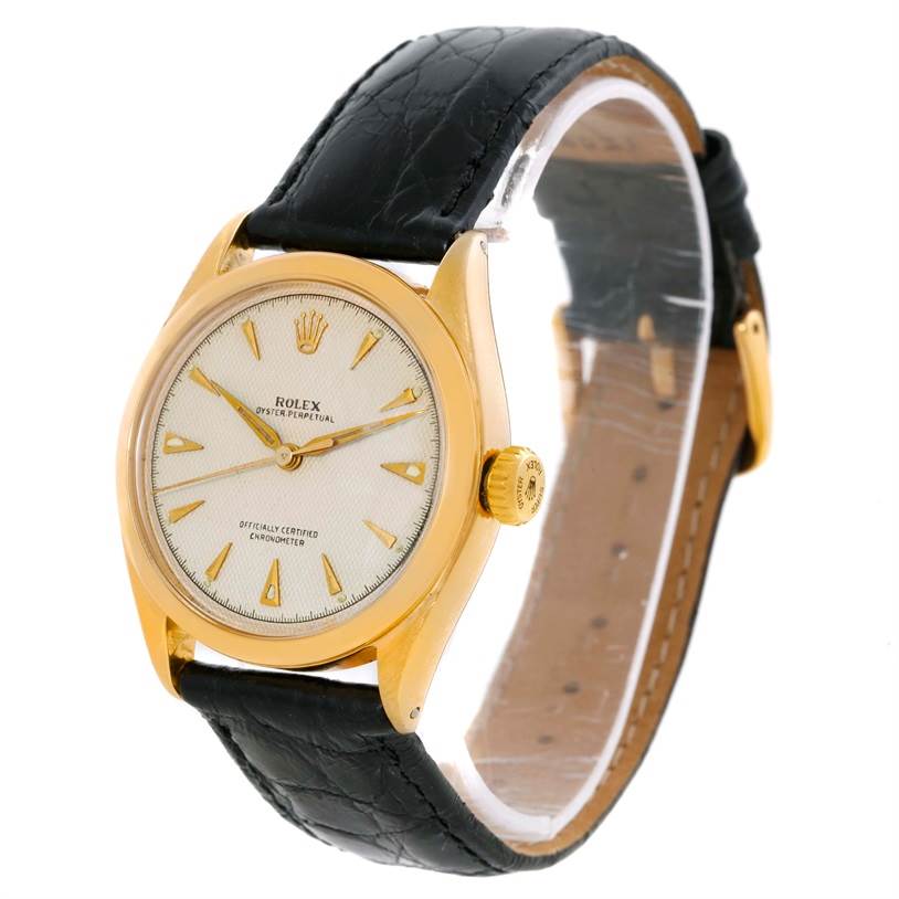 The Rolex Vintage Collection 6084 Men's Yellow Gold Silver Dial 6084 Men's Yellow Gold Silver Dial watch is shown from a front angle, displaying its dial, case, crown, and leather strap.