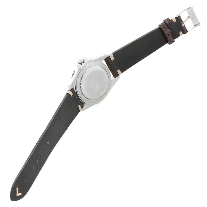 The image shows the back view of a Rolex Vintage Collection 1675 Men's Stainless Steel Black Dial 1675 Men's Stainless Steel Black Dial model watch with a visible strap and buckle.